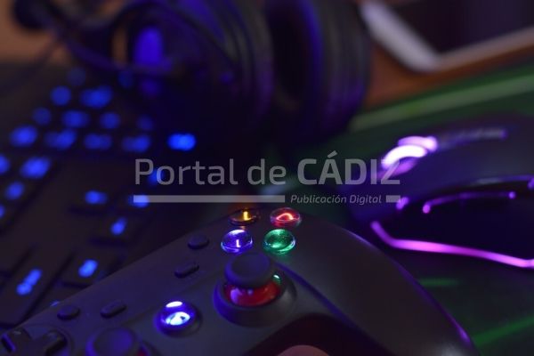modern gamepad and gaming mouse lies with keyboard and headphones on table in dark playroom scene t20 kvr7l9