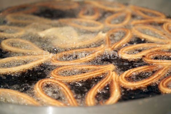 churro dough cooking in boiling oil 2022 12 01 06 01 35 utc