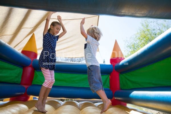 happy siblings jumping on bouncy castle 2021 08 28 16 46 33 utc