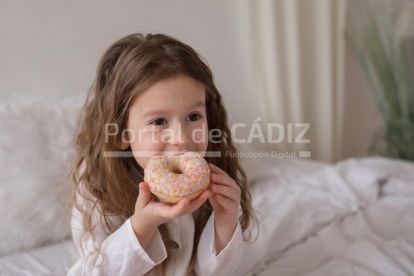 a girl eating donuts on the bed 2022 11 16 19 12 09 utc