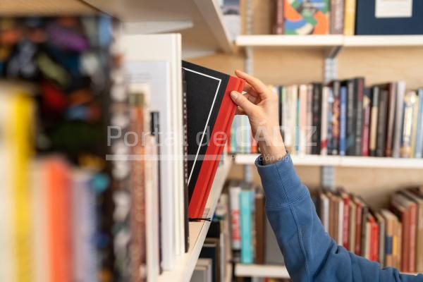 woman hand picking book from bookshelf in library 2022 04 14 15 30 17 utc